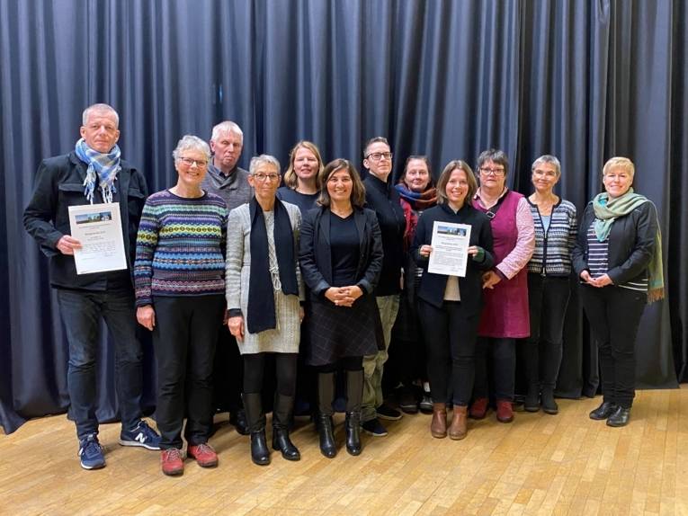 Damen und Herren stehen nebeneinander für ein gemeinsames Foto